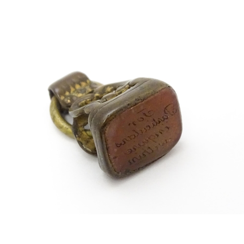 863 - A Victorian fob with engraved seal under. Together with a hallmarked silver locket of oval form with... 