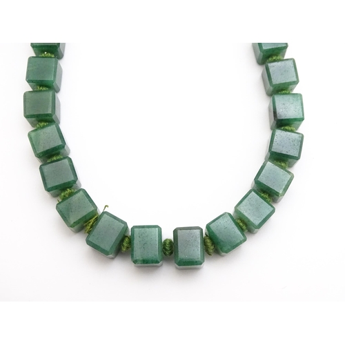 889 - A quantity of assorted green bead necklaces to include jade coloured beads, hardstone, malachite, et... 