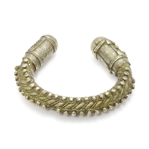 909 - A silver Bedouin torque bracelet of bangle form