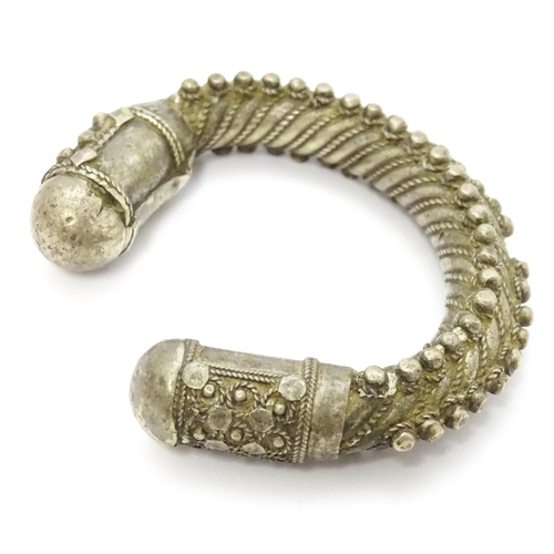 909 - A silver Bedouin torque bracelet of bangle form