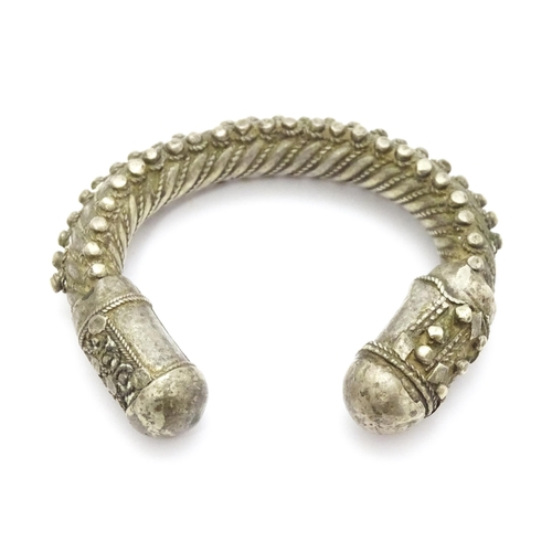 909 - A silver Bedouin torque bracelet of bangle form