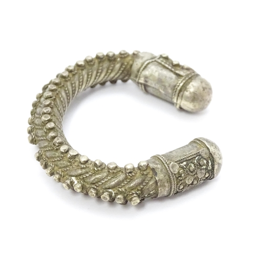 909 - A silver Bedouin torque bracelet of bangle form