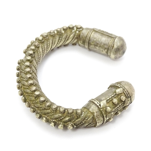 909 - A silver Bedouin torque bracelet of bangle form