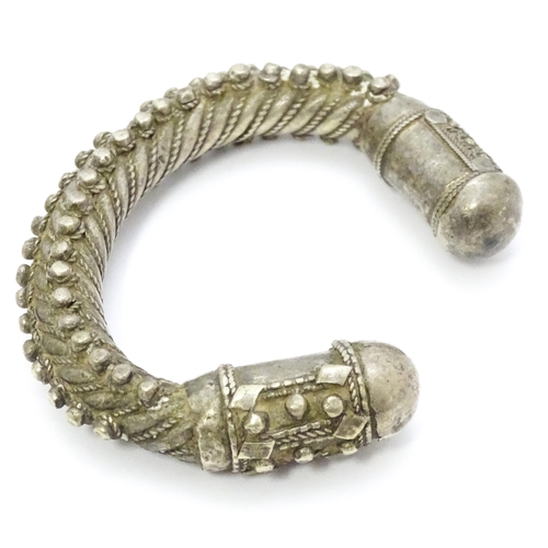 909 - A silver Bedouin torque bracelet of bangle form