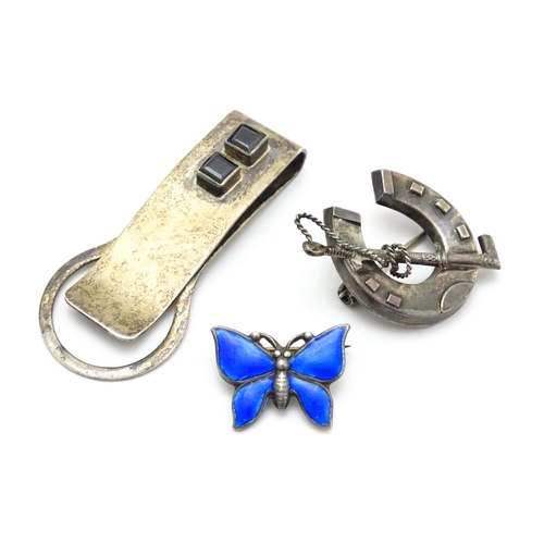 910 - A Victorian silver brooch with horseshoe and riding crop detail, a silver brooch of butterfly form w... 