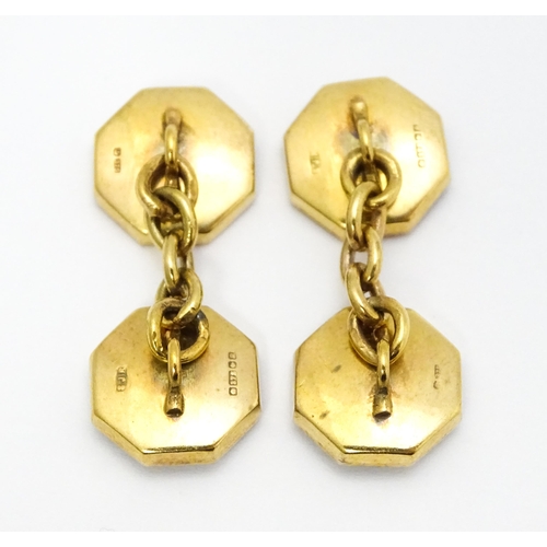 919 - A pair of 9ct gold cufflinks of octagonal form with mother of pearl and enamel detail. Approx. 1/2