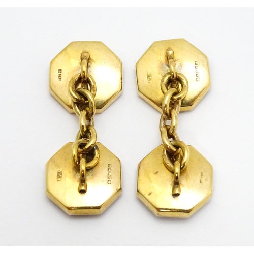 919 - A pair of 9ct gold cufflinks of octagonal form with mother of pearl and enamel detail. Approx. 1/2