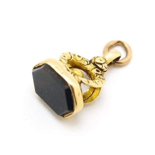 920 - A 9ct gold fob set with bloodstone seal. Approx. 3/4