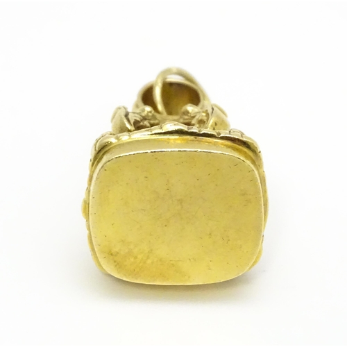 921 - A yellow metal pendant fob seal with acanthus scroll detail. Approx. 1 1/4