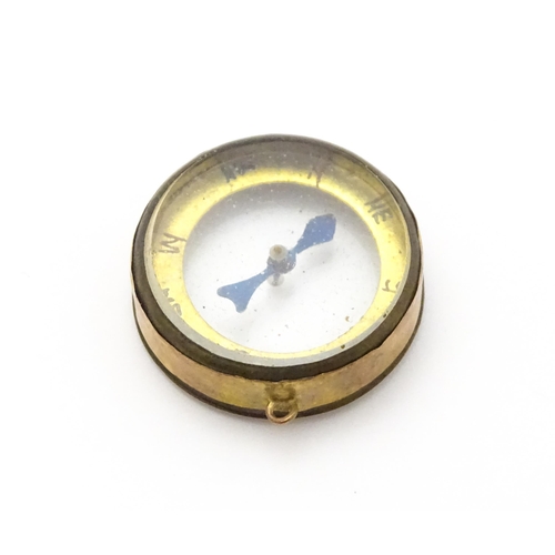 953 - A pendant charm formed as a compass within a 9ct gold mount, hallmarked Chester 1913, maker Thomas J... 