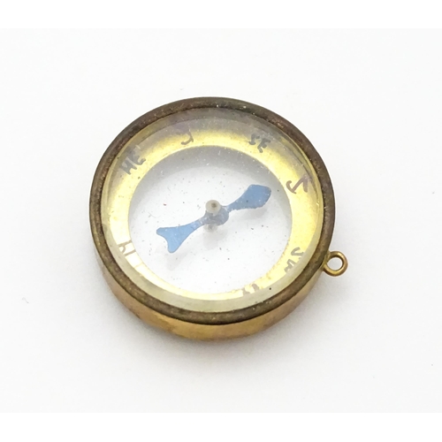 953 - A pendant charm formed as a compass within a 9ct gold mount, hallmarked Chester 1913, maker Thomas J... 