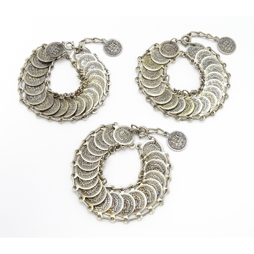 955 - Three bracelets with coin style detail. (3)