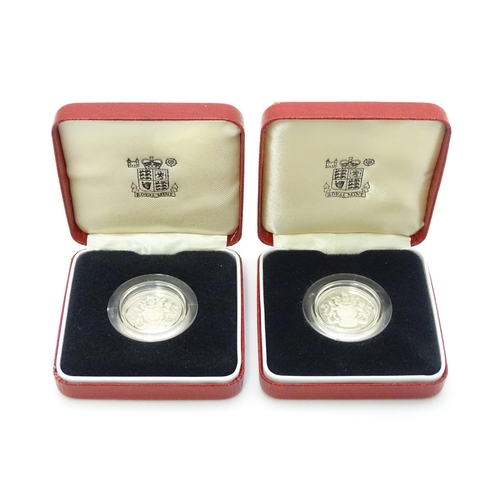 956 - Coins: Two silver proof £1 coins. Boxed. (2)