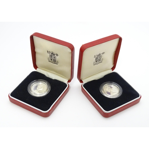 956 - Coins: Two silver proof £1 coins. Boxed. (2)