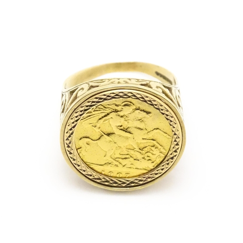 960 - A 9ct gold ring set with a half sovereign coin. Ring size approx. S 1/2