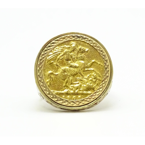 960 - A 9ct gold ring set with a half sovereign coin. Ring size approx. S 1/2