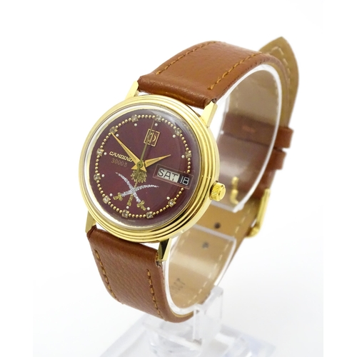 945 - A Candino 3000S wristwatch, the gold plated stainless steel case with a red guilloche enamel dial wi... 