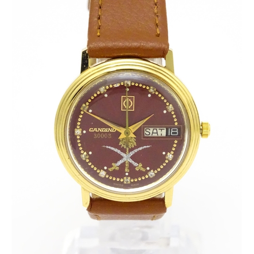 945 - A Candino 3000S wristwatch, the gold plated stainless steel case with a red guilloche enamel dial wi... 