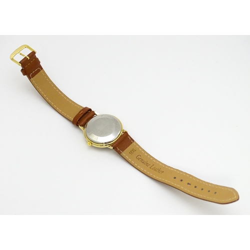 945 - A Candino 3000S wristwatch, the gold plated stainless steel case with a red guilloche enamel dial wi... 