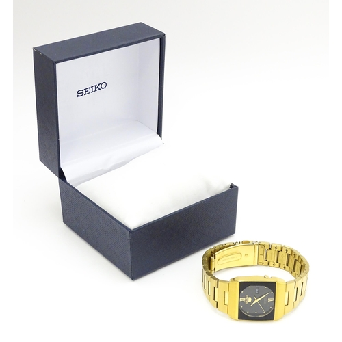 948 - A Seiko 5 gold plated wristwatch with automatic 21 jewel movement, the black dial with day and date ... 