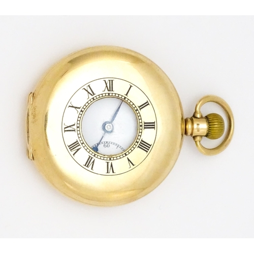 927 - A 9ct gold cased half hunter side wind pocket watch, the white enamel dial with Roman numerals and s... 