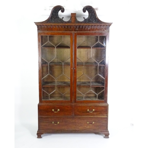 1530 - A George II / George III low waisted bookcase with an impressive swans neck architectural pediment w... 