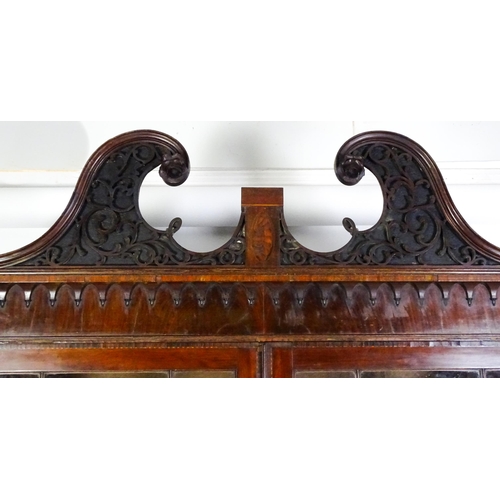 1530 - A George II / George III low waisted bookcase with an impressive swans neck architectural pediment w... 