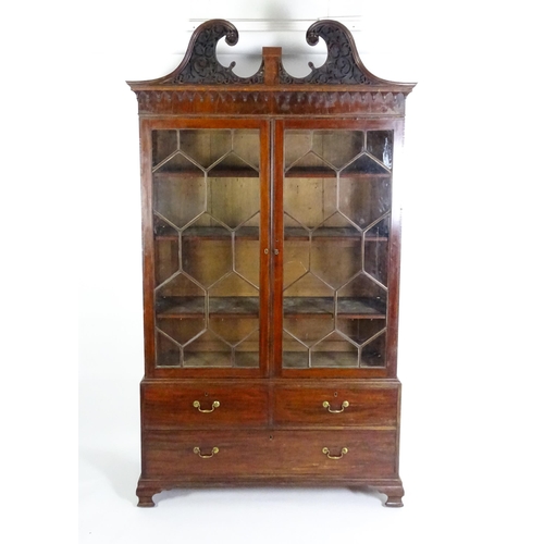 1530 - A George II / George III low waisted bookcase with an impressive swans neck architectural pediment w... 