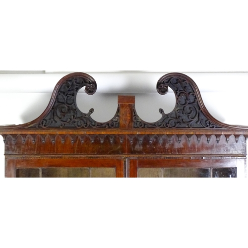 1530 - A George II / George III low waisted bookcase with an impressive swans neck architectural pediment w... 