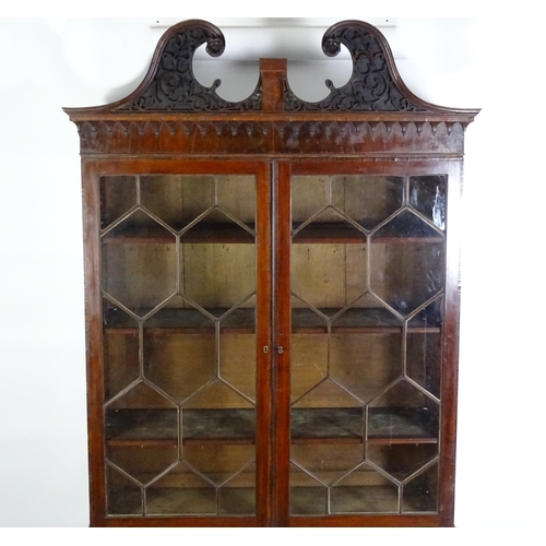 1530 - A George II / George III low waisted bookcase with an impressive swans neck architectural pediment w... 