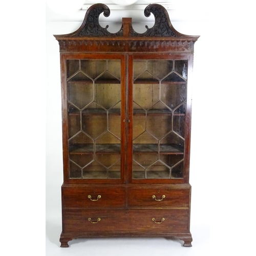 1530 - A George II / George III low waisted bookcase with an impressive swans neck architectural pediment w... 