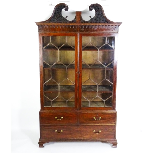 1530 - A George II / George III low waisted bookcase with an impressive swans neck architectural pediment w... 