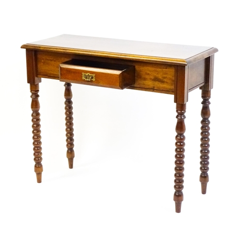 1583 - A mahogany side table / console table with a moulded rectangular top above a single frieze drawer an... 