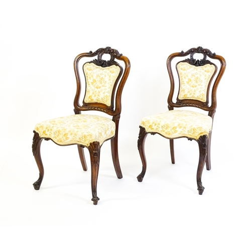 1701 - A pair of mid 19thC rosewood side chairs with acanthus carved top rails above shield shaped, upholst... 