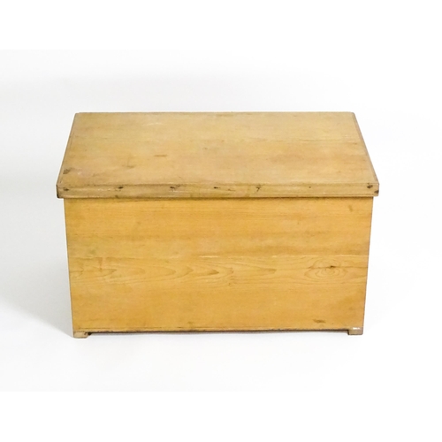 1711 - A 20thC pine trunk with a hinged lid, measuring 31