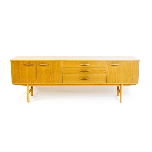 1759 - Vintage / Retro: A teak sideboard by 'Avalon'. The sideboard having three cupboards  and three drawe... 