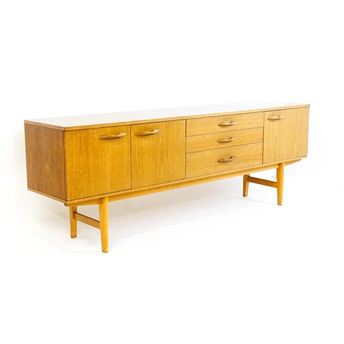 1759 - Vintage / Retro: A teak sideboard by 'Avalon'. The sideboard having three cupboards  and three drawe... 