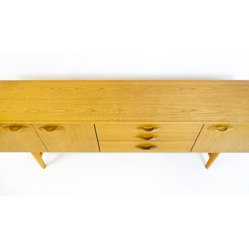 1759 - Vintage / Retro: A teak sideboard by 'Avalon'. The sideboard having three cupboards  and three drawe... 