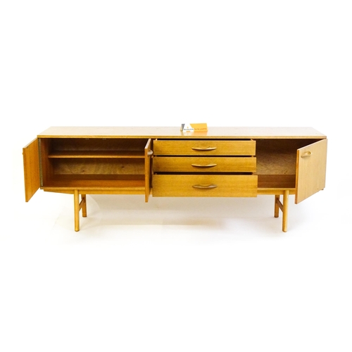 1759 - Vintage / Retro: A teak sideboard by 'Avalon'. The sideboard having three cupboards  and three drawe... 