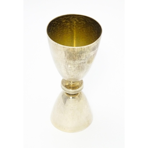 269 - A silver double ended spirit measure / jigger with gilded interiors. Hallmarked Birmingham 1965, mak... 