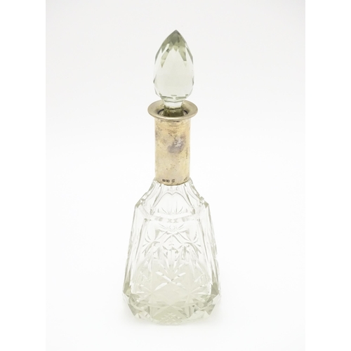 326 - A cut glass scent / perfume bottle / flask with German .800 silver mount. Approx. 8 1/2