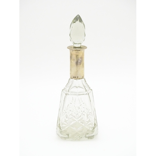 326 - A cut glass scent / perfume bottle / flask with German .800 silver mount. Approx. 8 1/2