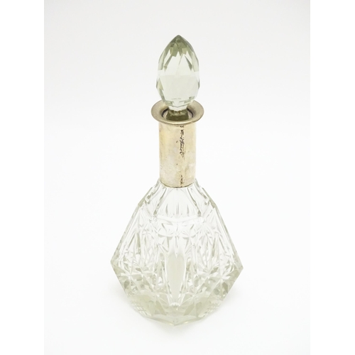 326 - A cut glass scent / perfume bottle / flask with German .800 silver mount. Approx. 8 1/2