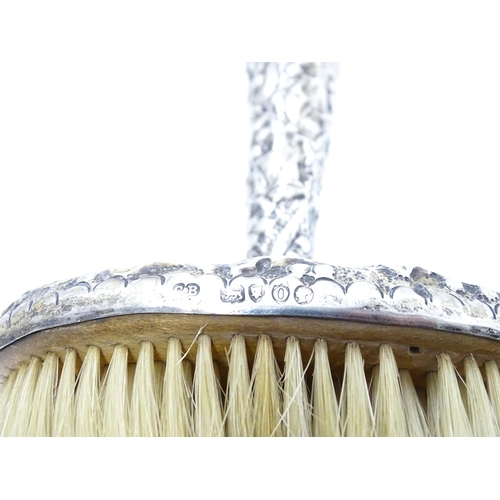 357 - A Victorian silver handled hat brush with foliate decoration, hallmarked London 1889, maker Charles ... 