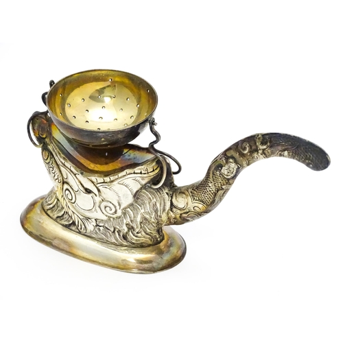 380 - A Vietnamese export .900 silver tea strainer stand, the stand of stylised open mouthed dragon head f... 