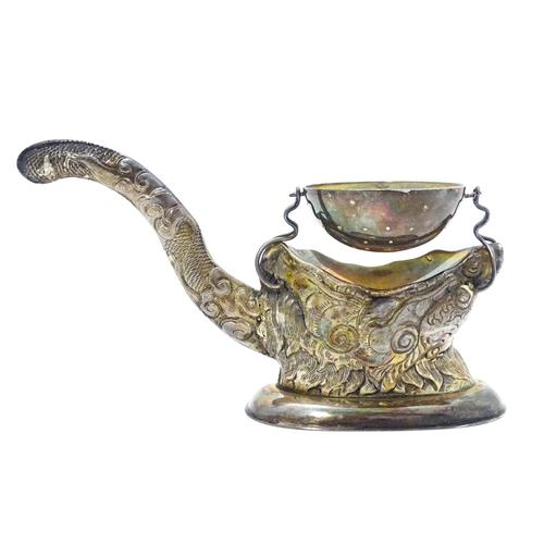 380 - A Vietnamese export .900 silver tea strainer stand, the stand of stylised open mouthed dragon head f... 