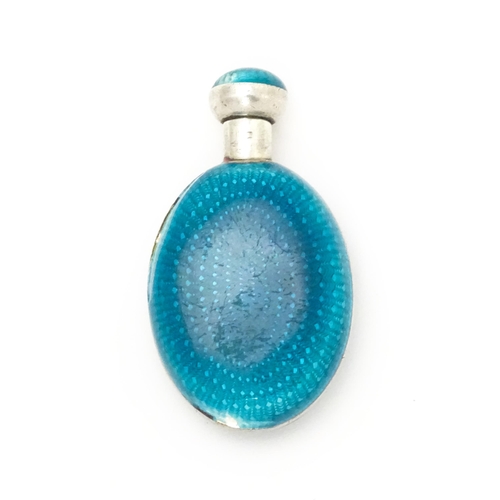 404 - A white metal scent / perfume bottle with turquoise guilloche enamel decoration. Indistinctly marked... 