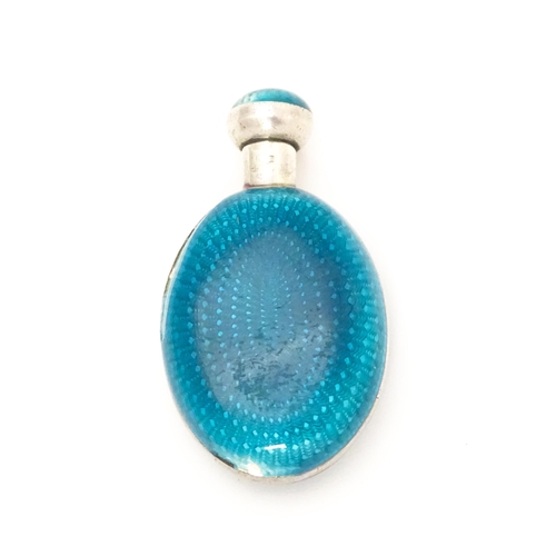 404 - A white metal scent / perfume bottle with turquoise guilloche enamel decoration. Indistinctly marked... 