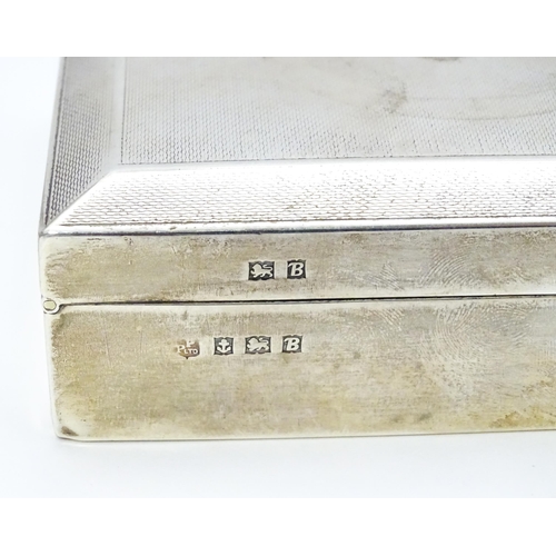 427 - A silver cigarette box with engine turned decoration hallmarked Birmingham 1951, maker Poston Produc... 