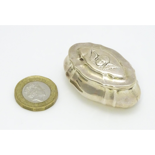 429 - A Victorian silver pill box the hinged lid with angel head decoration, hallmarked Birmingham 1899, m... 